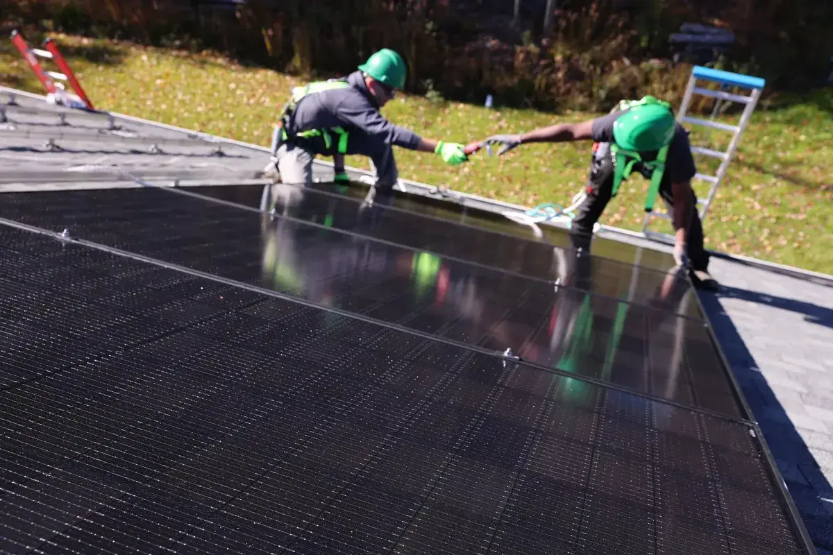 Greenfoot solar crew installing solar panels on a residential roof